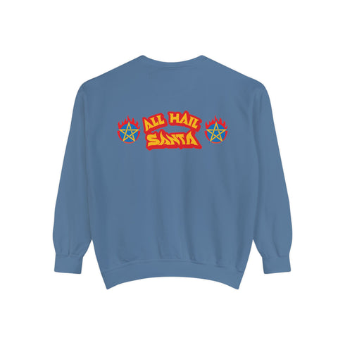 A Christmas sweatshirt featuring a playful design with a cartoon Baphomet goat character wearing a Santa hat. The design includes the text "All Hail Santa" above the goat, with pentagrams in flames on either side. The goat is depicted in a meditative pose, adding a humorous and irreverent twist to holiday attire.